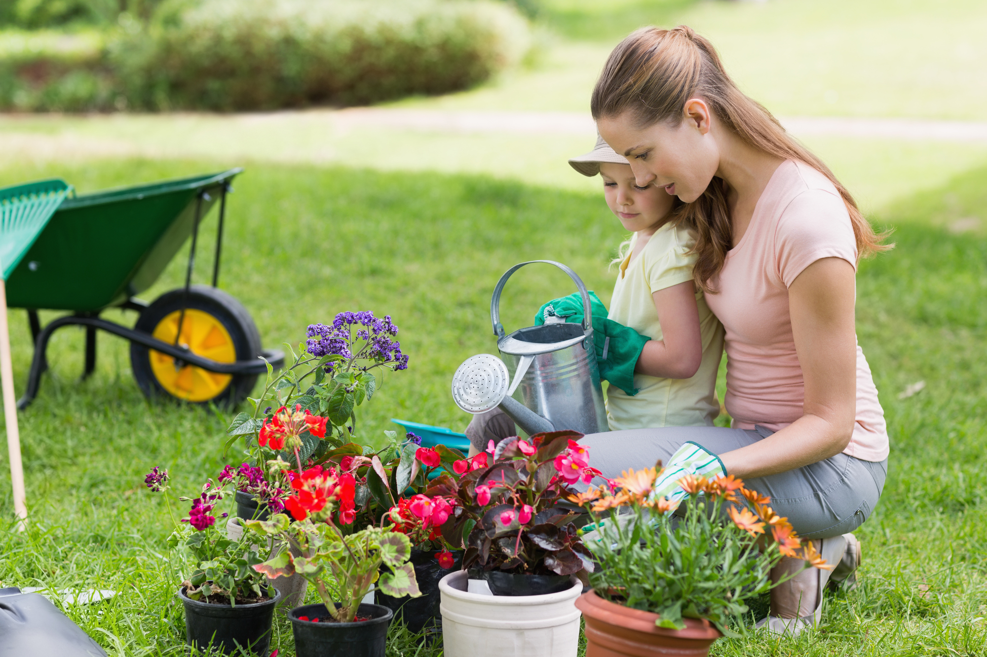 Side view of a mother and daughter engaged in gardening